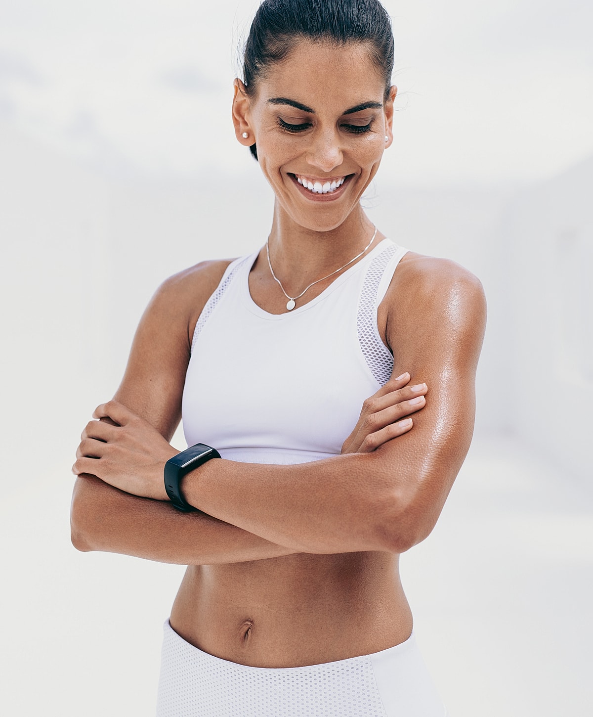 Wasilla Body Contouring model in athletic wear with smartwatch.