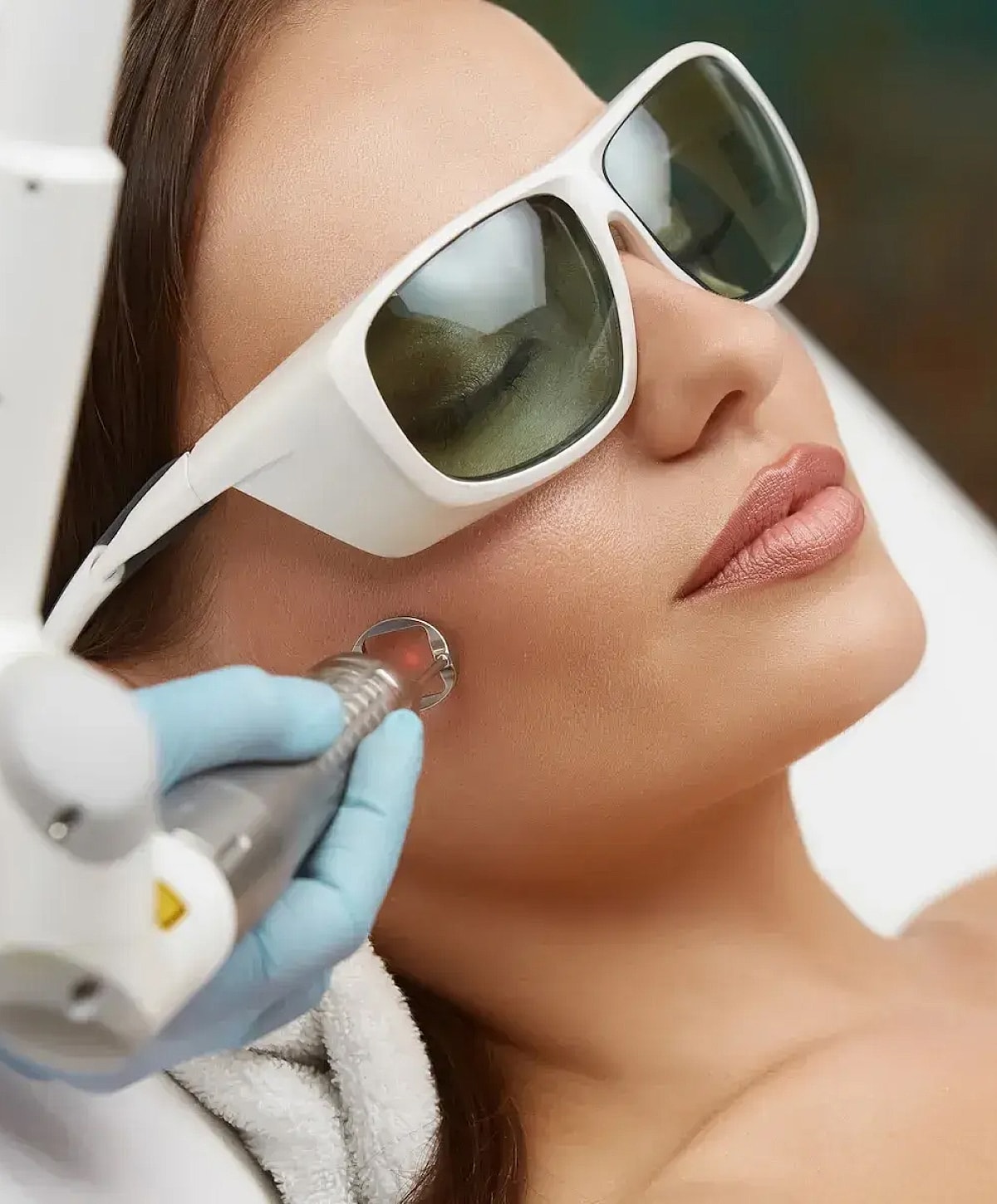 Woman with closed eyes enjoying the sunlight.