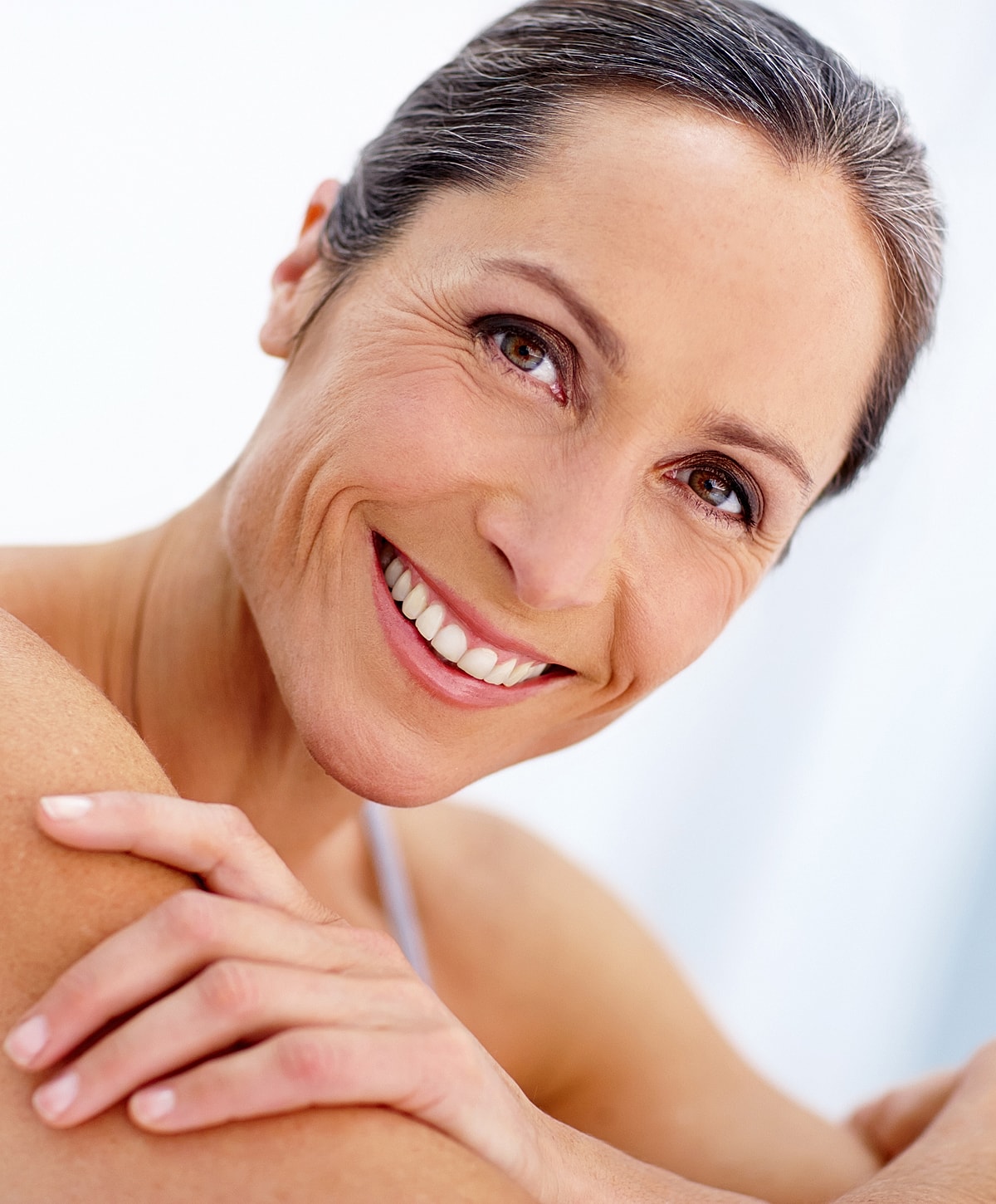 Smiling mature woman with healthy, glowing skin.