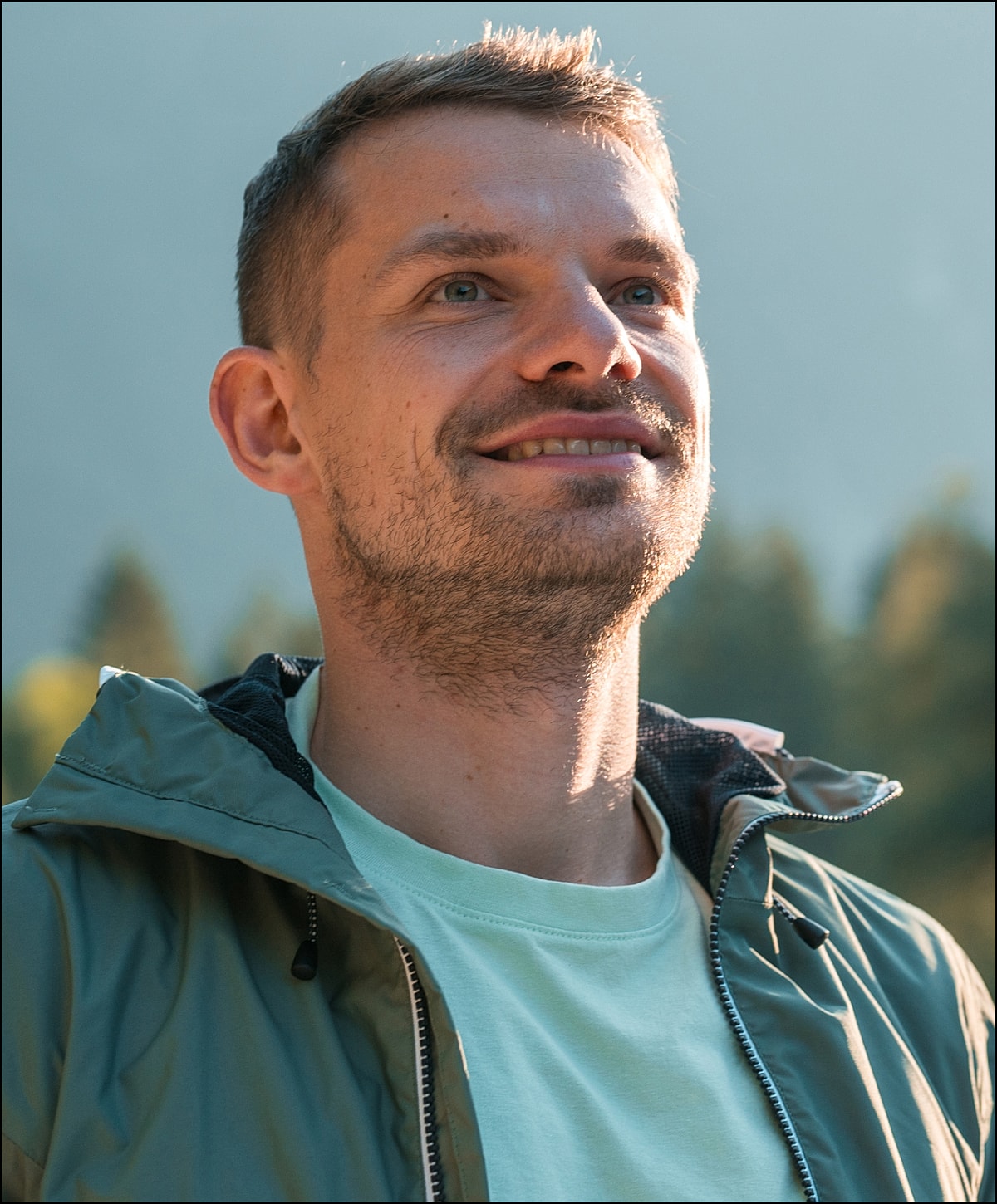Smiling woman leaning against a wall.