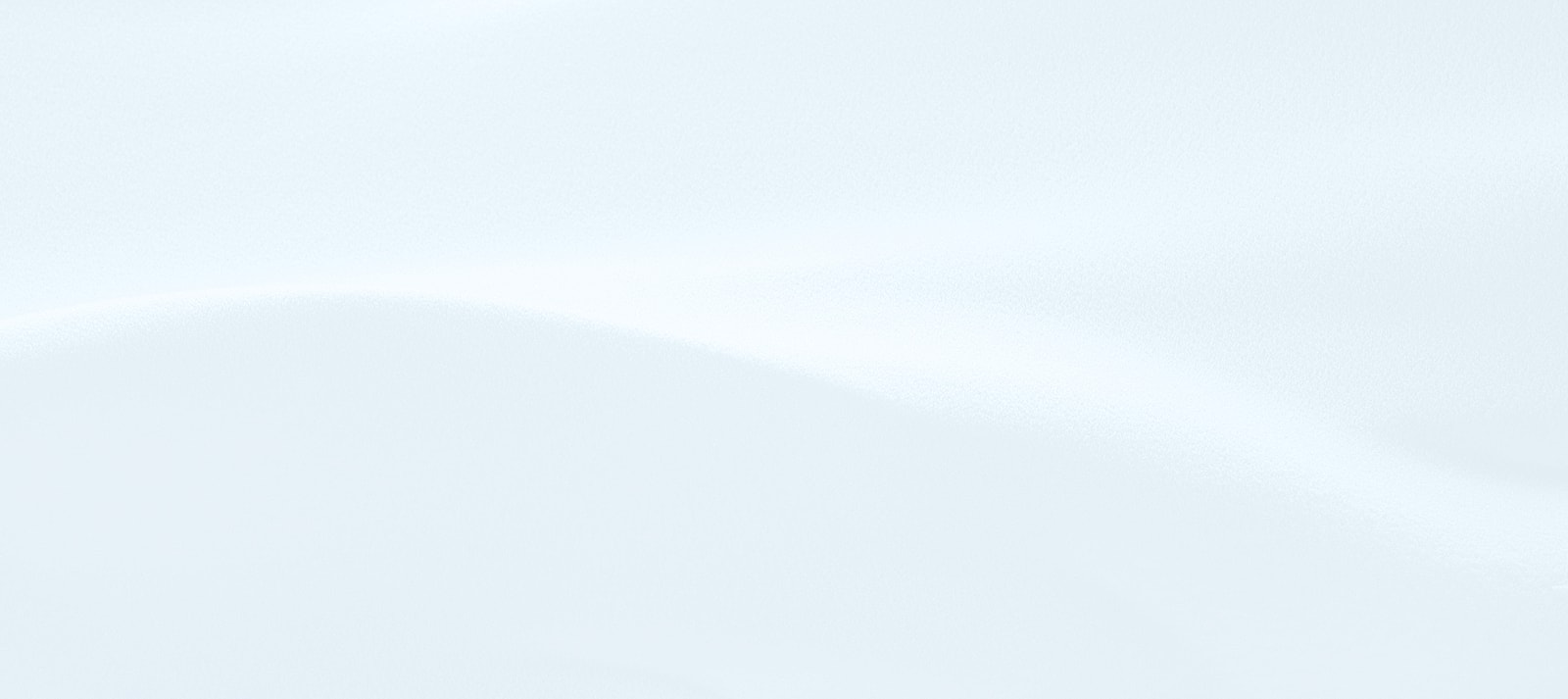 Smooth, white snow surface with gentle curves.