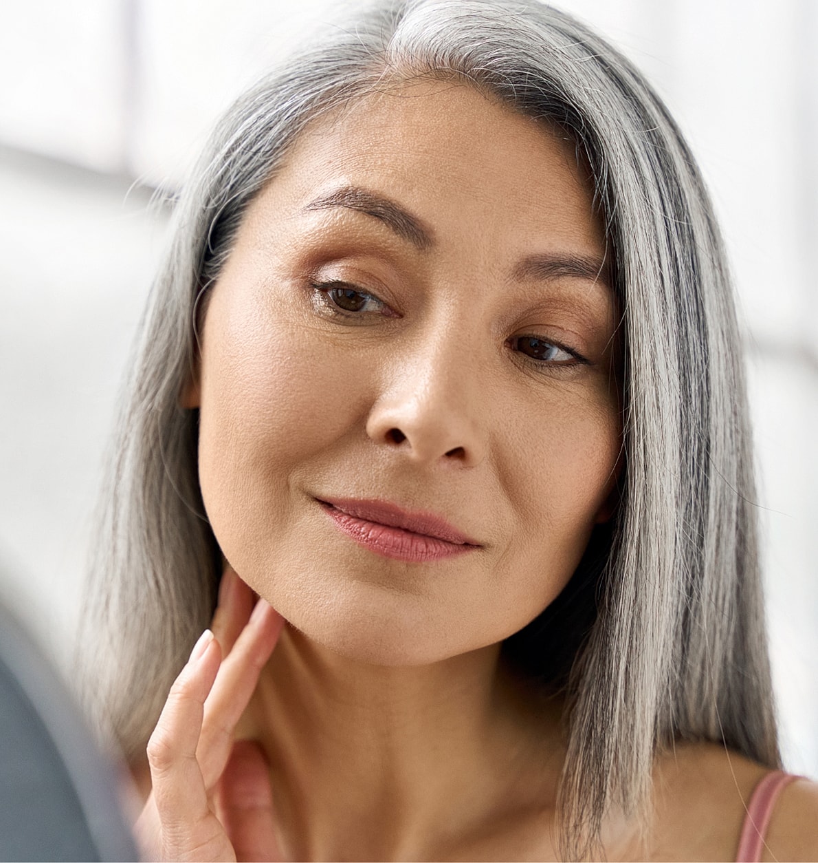 Smiling woman with flowing hair at sunset.